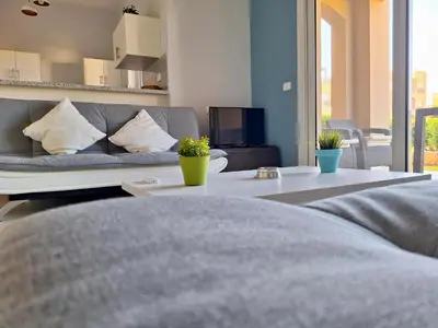 a living room with a couch and a table at El Gouna Waterside E 1-Bedroom Ground Floor Sleeps 4 Persons in El Gouna