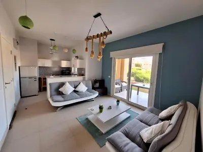 a living room with a couch and a table at El Gouna Waterside E 1-Bedroom Ground Floor Sleeps 4 Persons in El Gouna