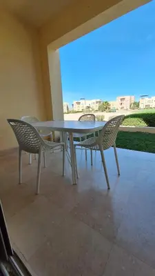 a table and chairs sitting on a patio at El Gouna Waterside E 1-Bedroom Ground Floor Sleeps 4 Persons in El Gouna