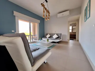 a living room with a couch and a table at El Gouna Waterside E 1-Bedroom Ground Floor Sleeps 4 Persons in El Gouna