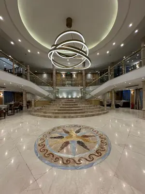 a lobby with a clock in the middle of a building at Orient Tower Prestige Nile Cruise-Every Monday from Luxor for 04 & 07 Nights - Every Friday From Aswan for 03 Nights in Luxor