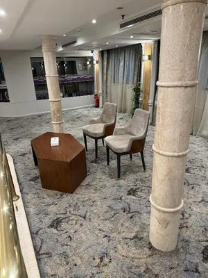 a lobby with chairs and a table and columns at Orient Tower Prestige Nile Cruise-Every Monday from Luxor for 04 & 07 Nights - Every Friday From Aswan for 03 Nights in Luxor