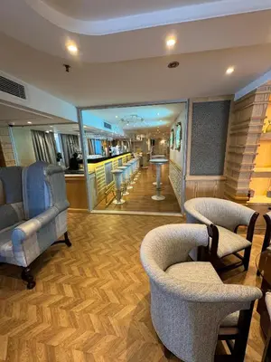 a room with chairs and a bar with a mirror at Orient Tower Prestige Nile Cruise-Every Monday from Luxor for 04 & 07 Nights - Every Friday From Aswan for 03 Nights in Luxor