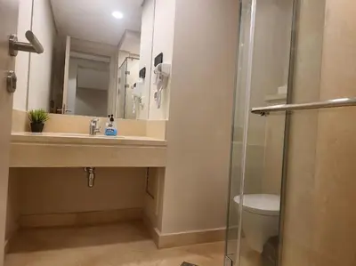 a bathroom with a sink and a toilet and a mirror at Mangroovy- 1BR Sparkling Condo in Hurghada