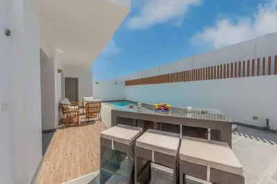 a balcony with a table and chairs and a pool at Luxury Villa with private pool Sholan 2 in Hurghada