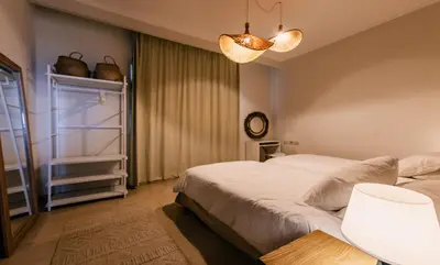 a bedroom with two beds and a clock on the wall at Luxury One Bedroom Apartment with Sea view in SomaBay in Hurghada