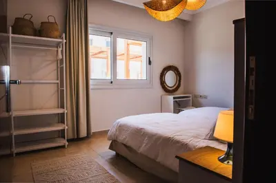 a bedroom with a bed and a window and a mirror at Luxury One Bedroom Apartment with Sea view in SomaBay in Hurghada