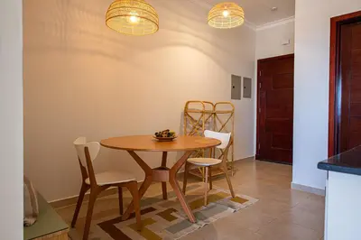 a dining room with a wooden table and chairs at Luxury One Bedroom Apartment with Sea view in SomaBay in Hurghada