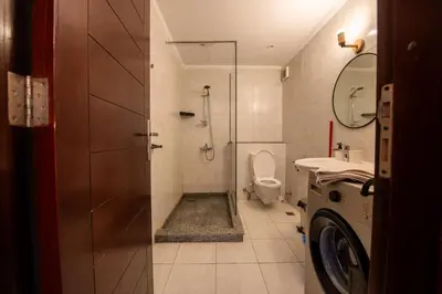 a bathroom with a shower and a toilet and a sink at Luxury One Bedroom Apartment with Sea view in SomaBay in Hurghada