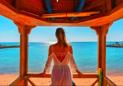 a woman in a white dress looking out at the ocean at Davinci Beach Resort in Hurghada