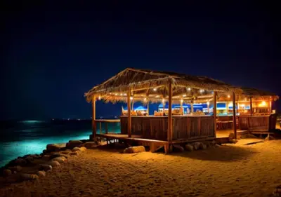 a restaurant on the beach at night at Davinci Beach Resort in Hurghada