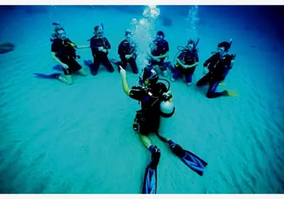 a group of people in wet suits in the water at Davinci Beach Resort in Hurghada