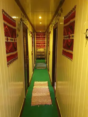 a long hallway with a green floor in a building at Moon Boat in Luxor