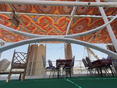 a group of chairs in a room with a ceiling at Moon Boat in Luxor