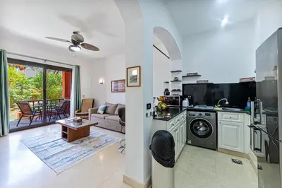 a kitchen and living room with a washer and dryer at Beautiful apartment with terrace to the pool in Hurghada