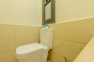a bathroom with a white toilet and a mirror at Sunny 1BR Retreat Newest Project Shedwan El Gouna Lagoon & Pool in Hurghada