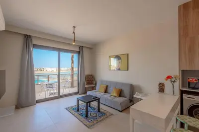 a living room with a couch and a view of the ocean at Sunny 1BR Retreat Newest Project Shedwan El Gouna Lagoon & Pool in Hurghada