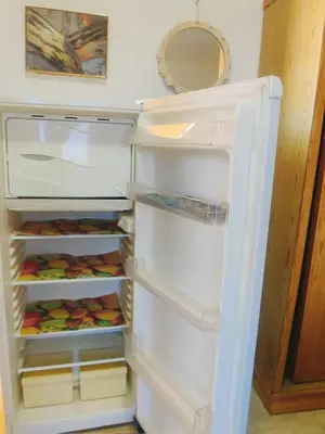 an empty refrigerator with its door open in a kitchen at Wavesong Whispers flat where you can enjoy seaview with the best price and enjoy speedy wifi in Hurghada