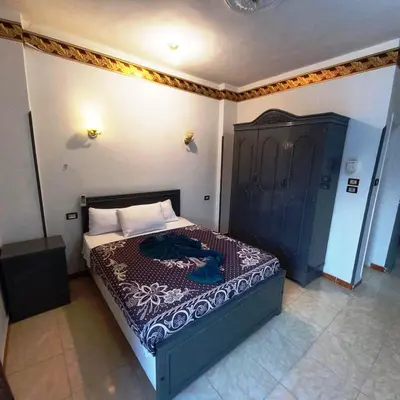 a bedroom with a large bed in a room at Pauline Guest House in Luxor