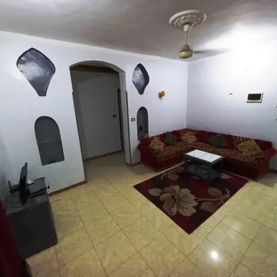 a living room with a couch and a table at Pauline Guest House in Luxor