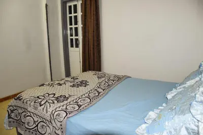 a bed with a blanket on it in a room at Pauline Guest House in Luxor