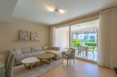 a living room with a couch and a table at Stylish Gouna Escape 2BR Mangroovy Beach Pool Access in Hurghada