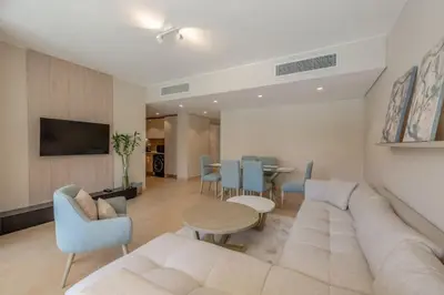 a living room with a couch and chairs and a table at Stylish Gouna Escape 2BR Mangroovy Beach Pool Access in Hurghada