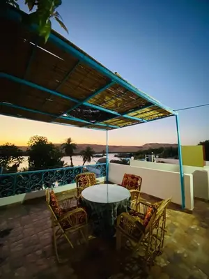 a patio with a table and chairs on a balcony at Basmatic2 Nubian Guest House in Aswan