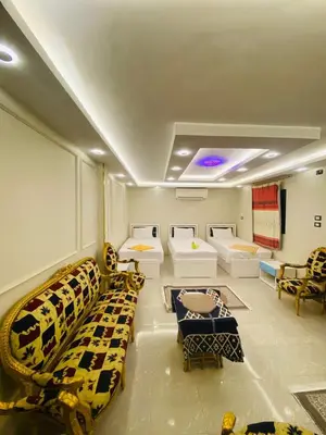 a room with couches and chairs in a room at Basmatic2 Nubian Guest House in Aswan