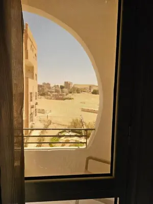 a window with a view of a desert from a building at الغردقة الدهار القيادات in Hurghada