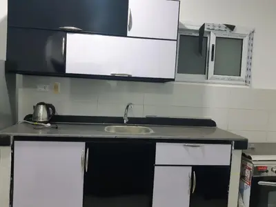 a kitchen counter with a sink and a microwave at الغردقة الدهار القيادات in Hurghada