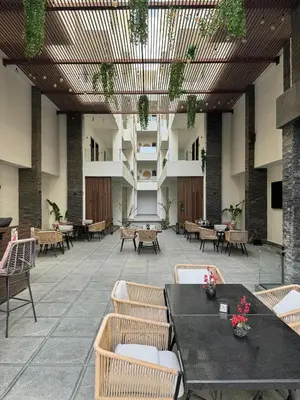 an empty restaurant with tables and chairs and plants at Imperial resort in Hurghada