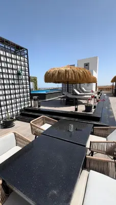 a patio with a table and chairs and a umbrella at Imperial resort in Hurghada