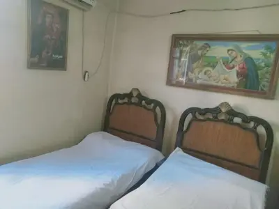 two beds sitting next to each other in a bedroom at Pito home in Luxor