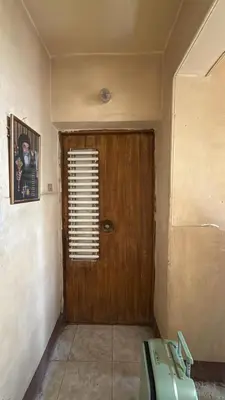 a room with a wooden door and a window at Pito home in Luxor