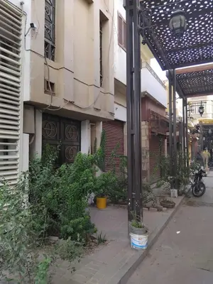 an empty street with a building with a bike parked next to it at Pito home in Luxor