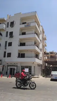 a man riding a motorcycle in front of a building at Pito home in Luxor