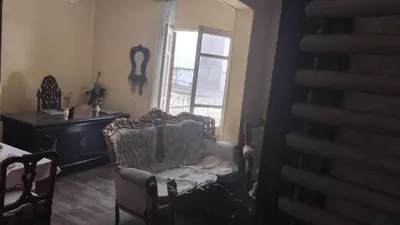 a living room with a chair and a window at Pito home in Luxor