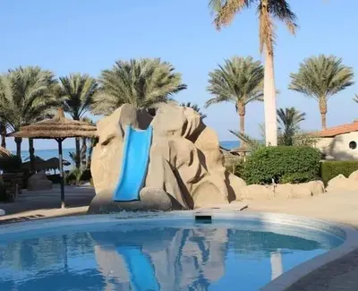 a pool in a resort with an elephant ride at بالما ريزورت in Hurghada