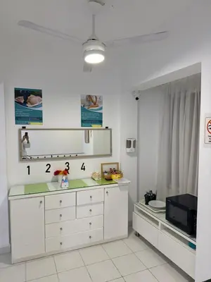 a kitchen with white cabinets and a microwave at Aden Beach - Sea View room with beach access in Villa in Hurghada