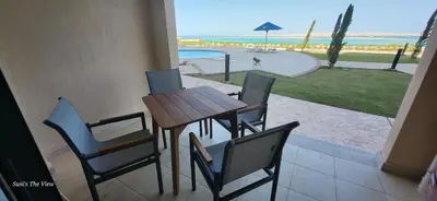 a table and chairs with a view of the ocean at Susi`s TheView Luxuriöse Ferienwohnung mit fantastischem Meerblick in Hurghada