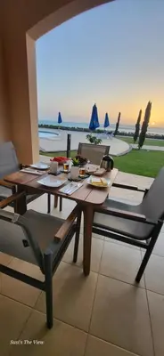 a dining table and chairs with a view of the ocean at Susi`s TheView Luxuriöse Ferienwohnung mit fantastischem Meerblick in Hurghada