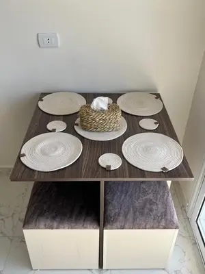 a table with plates and a basket on top at Benashti Hurghada apartment 407 in Hurghada
