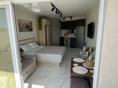 a bedroom with a bed and a couch and a table at Benashti Hurghada apartment 407 in Hurghada