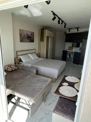 a hotel room with two beds and a table at Benashti Hurghada apartment 407 in Hurghada