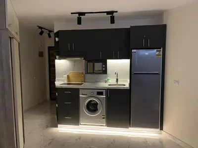 a kitchen with a refrigerator and a washing machine at Benashti Hurghada apartment 407 in Hurghada