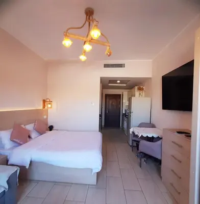 a hotel room with a large bed and a flat screen tv at ALDAU Heights Mountain View in Hurghada
