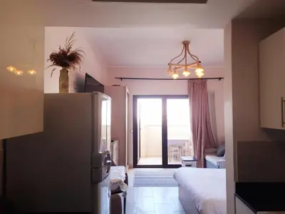 a bedroom with a bed and a large window at ALDAU Heights Mountain View in Hurghada