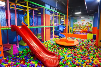 a playground filled with balls and a slide at ALDAU Heights Mountain View in Hurghada