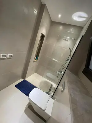 a bathroom with a toilet and a shower at ElGouna, Elegant 1Bedroom, private patio in Fanadir Marina in Hurghada